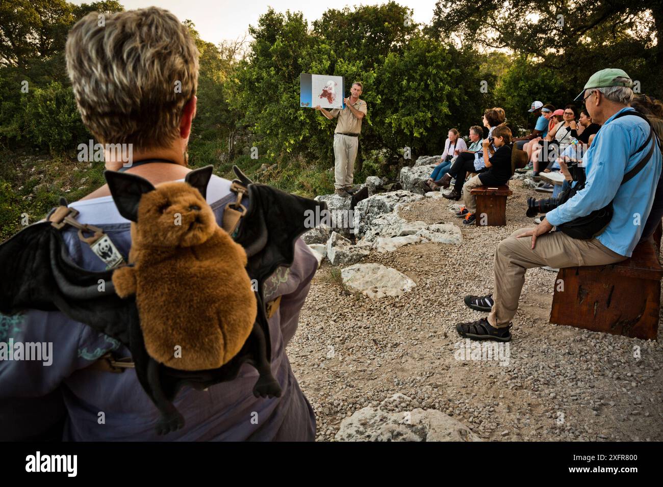 Visitors to Bracken Cave listening as Fran Hutchens, Bat Conservation International's director of Bracken Cave Preserve, gives educational information to visitors about the lives and existence of the Mexican free-tailed bat. Bracken Cave, San Antonio, Texas, USA, July 2015. Stock Photo