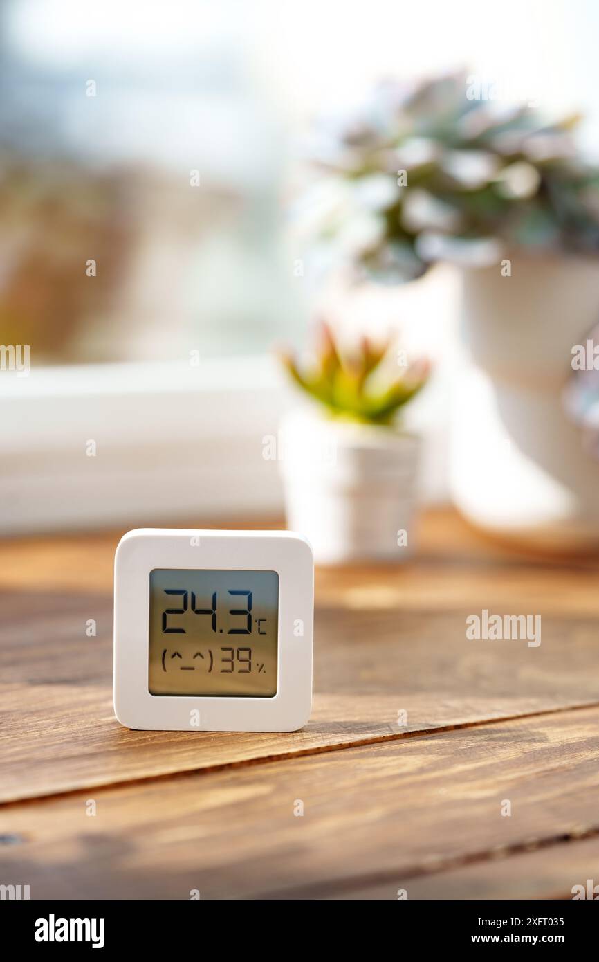 Digital Thermometer Displaying Temperature and Humidity Near Window ...