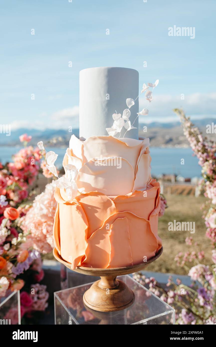 Colorful tiered modern wedding cake with florals Stock Photo - Alamy