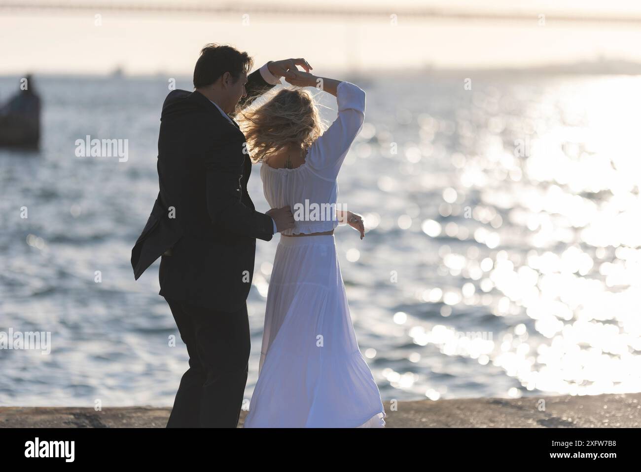 Couple Dancing at Sunset by the Sea Stock Photo - Alamy