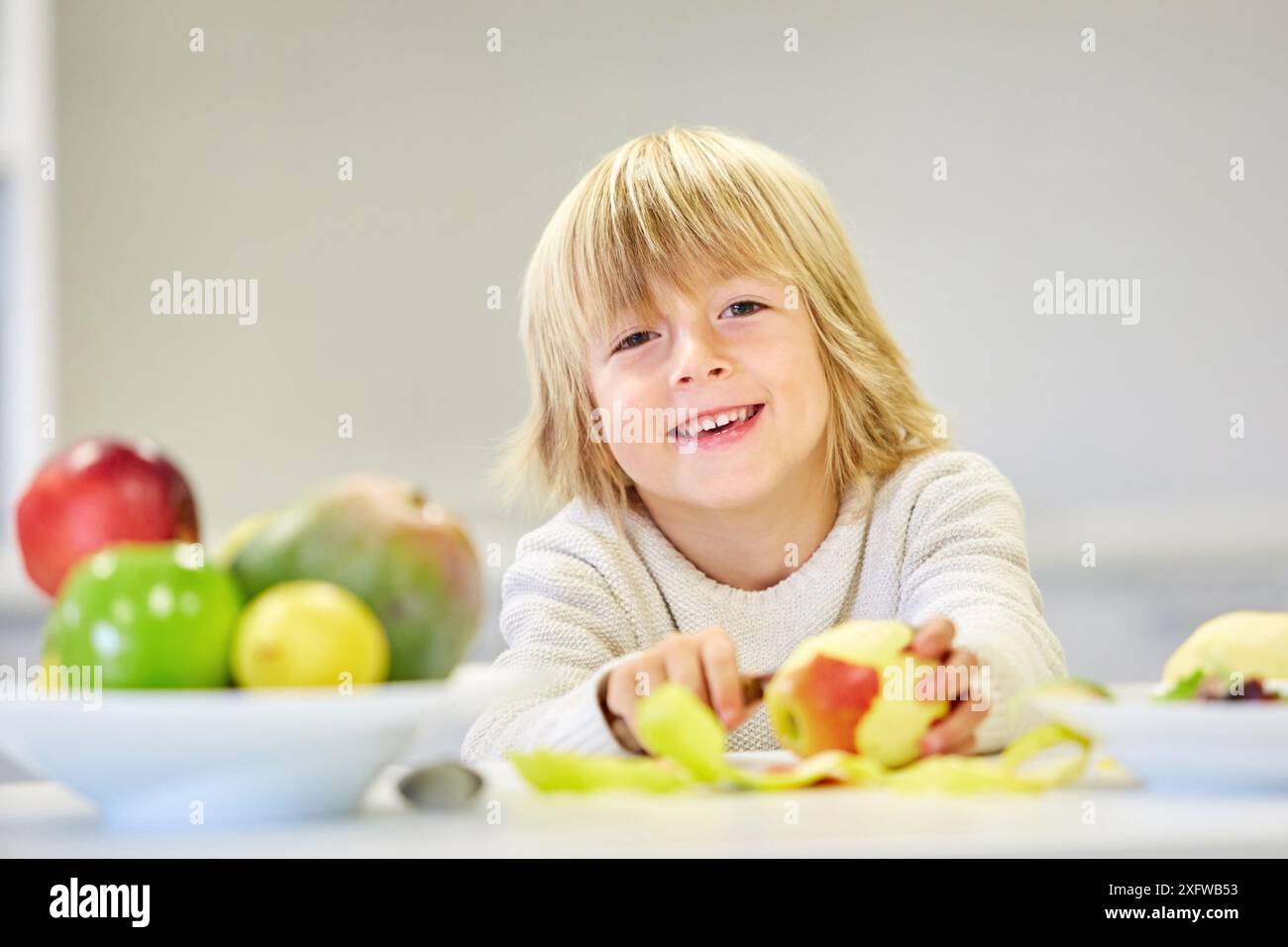 Family in the kitchen. Child. Healthy eating. Healthy growth. Eating an apple. Stock Photo