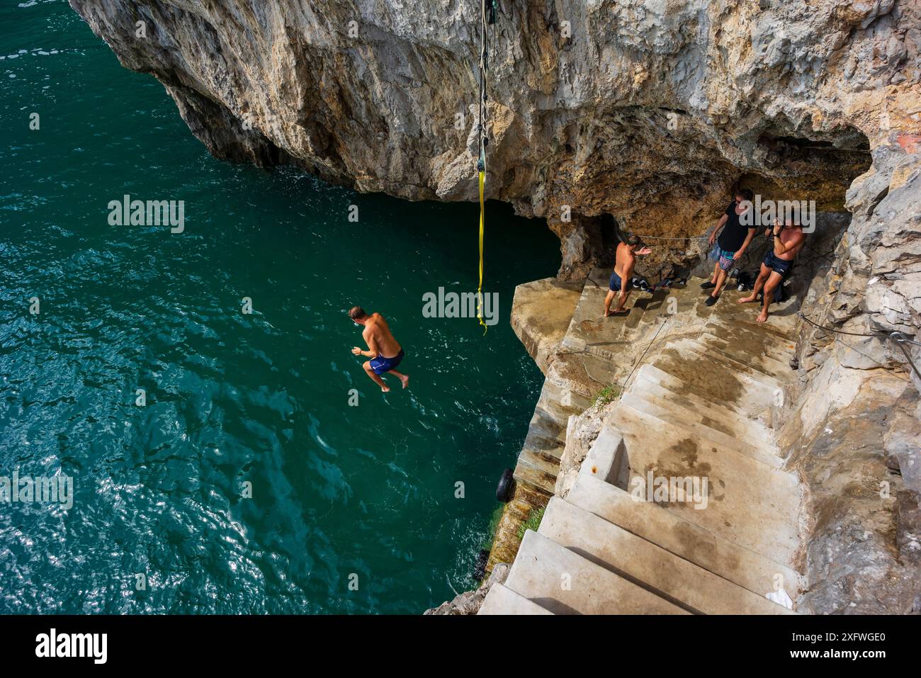 jumping into the sea, cliffs of Del Caballo lighthouse, Buciero mountain, Santoña, Cantabria, Spain. Stock Photo