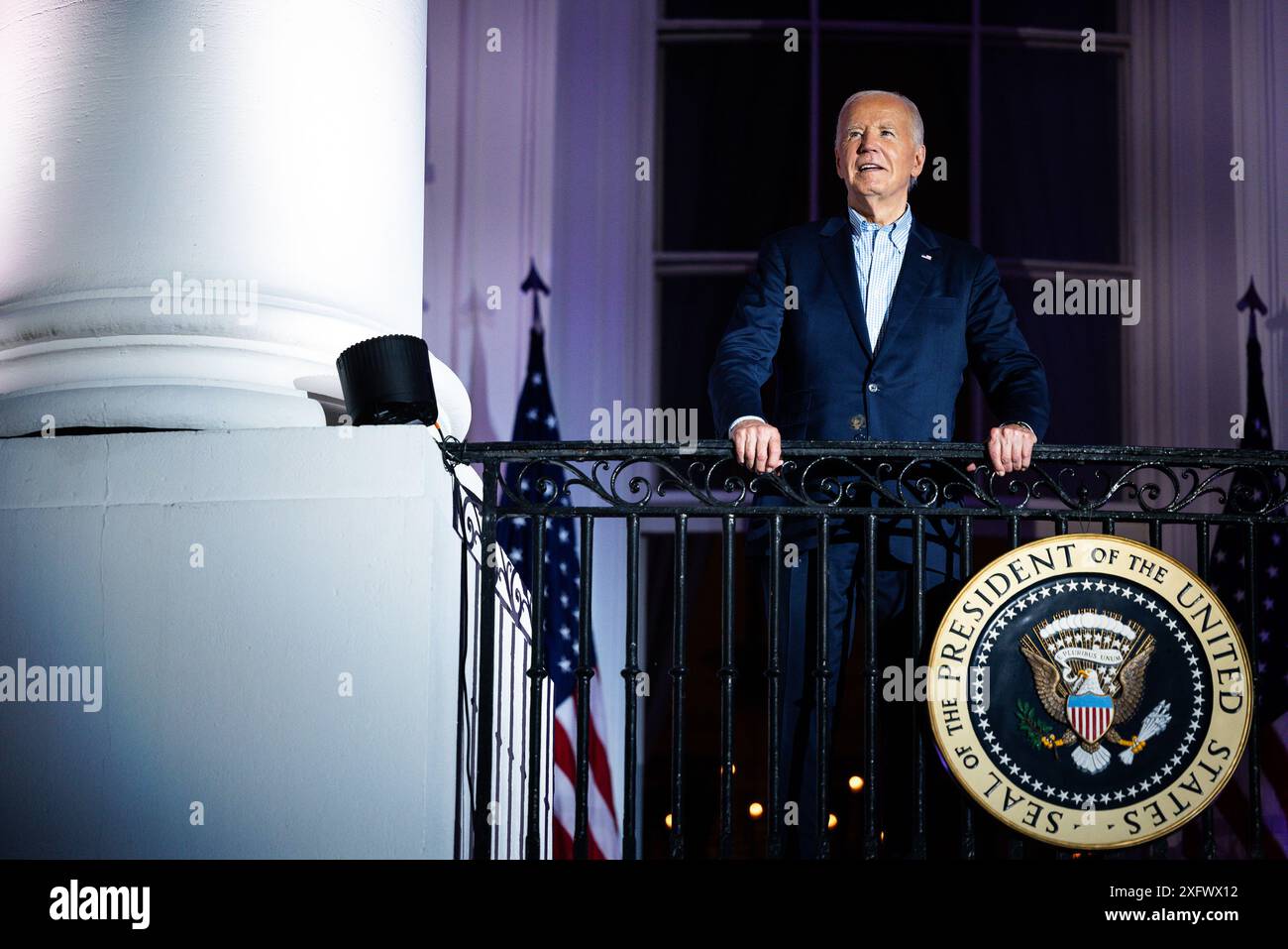 United States President Joe Biden arrives to view the Independence Day fireworks display over the National Mall from the Truman Balcony of the White House in Washington, DC, US, on Thursday, July 4, 2024. Biden's reelection campaign limped into the US Independence Day holiday, exhausted by a week of the incumbent clawing to maintain his hold on his party's nomination. Credit: Tierney L. Cross/Pool via CNP /MediaPunch Stock Photo