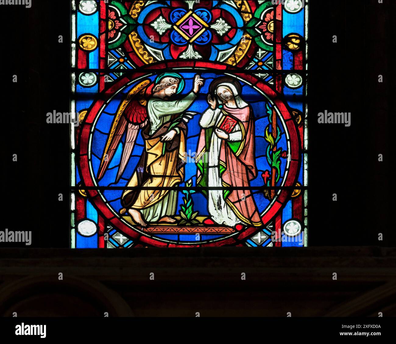 Angel Gabriel tells Mary she is to conceive by the Holy Spirit and have a son named Jesus ; window in the christian medieval gothic cathedral in Linco Stock Photo