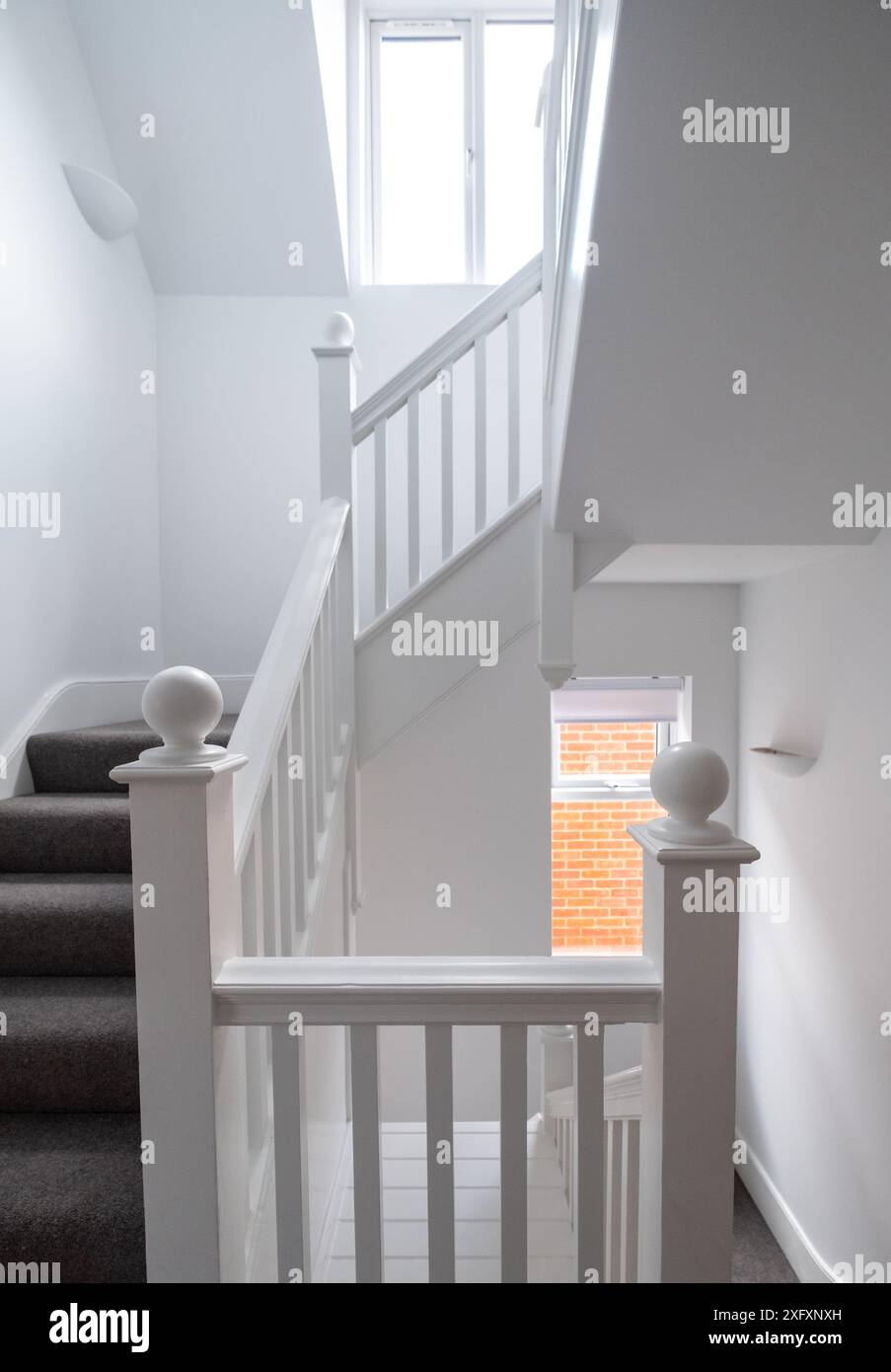 Renovated, white painted, wooden staircase with simple vertical slats ...