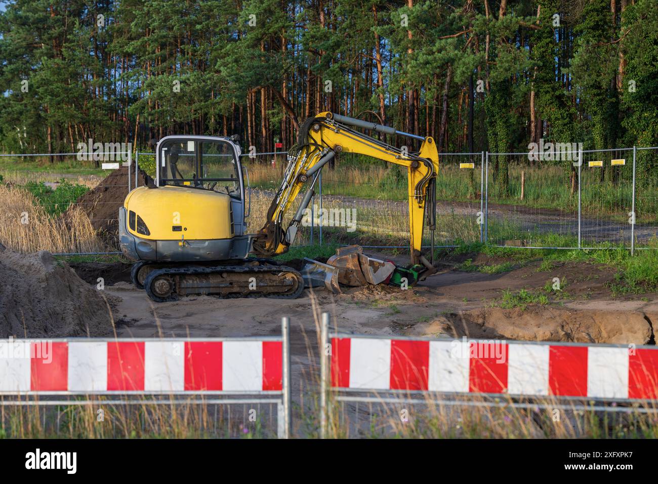 A small excavator on a construction site Stock Photo