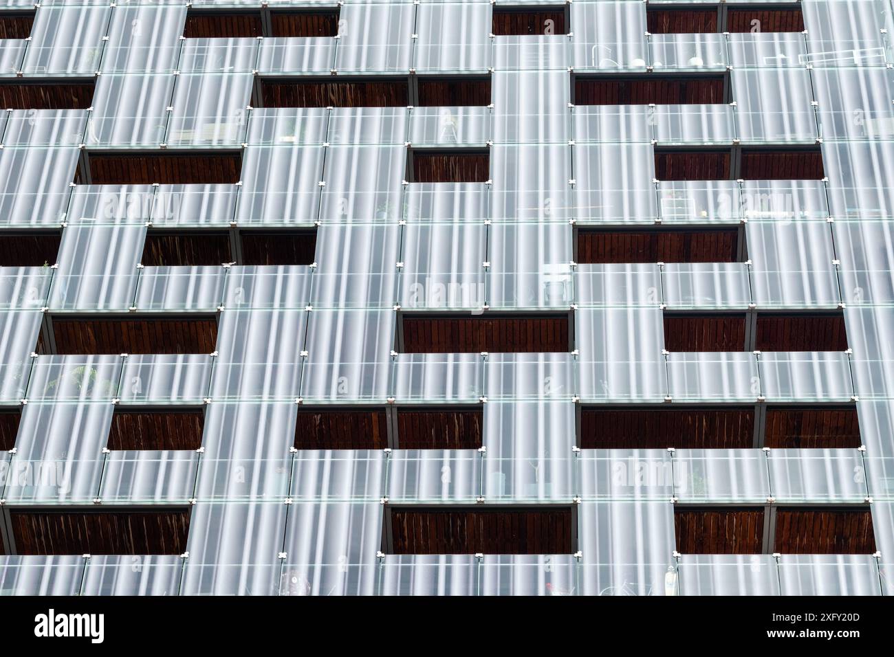 Staggered Window Pattern The building has a lot of windows, and the windows are arranged in a ...