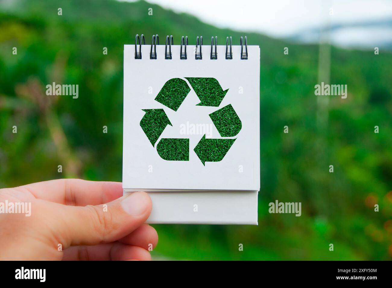 Recycle symbol on white notepad with nature beauty background. Reuse ...