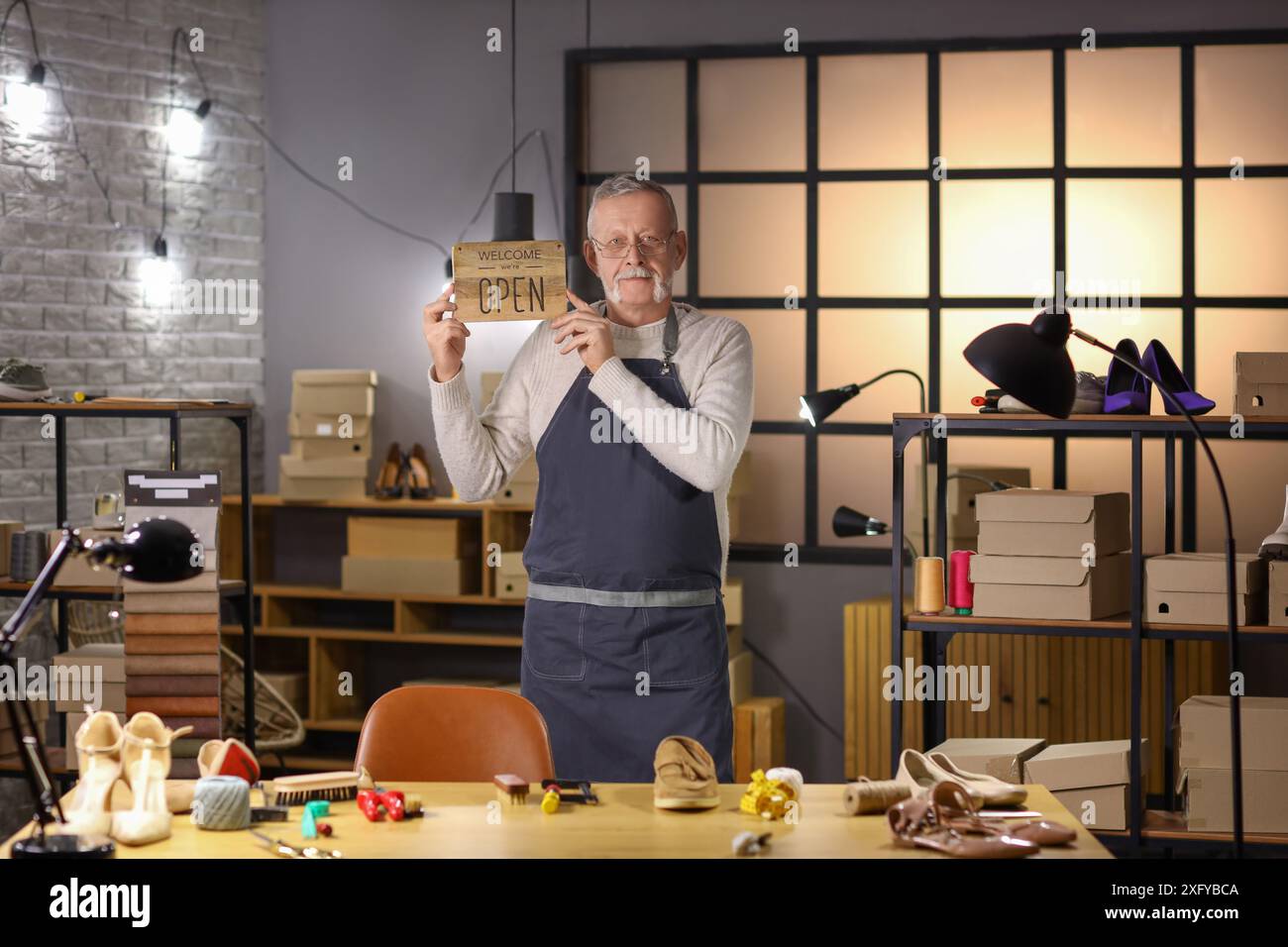 Shoemaker Open Sign Mature shoemaker with OPEN sign in workshop Stock Photo - Alamy