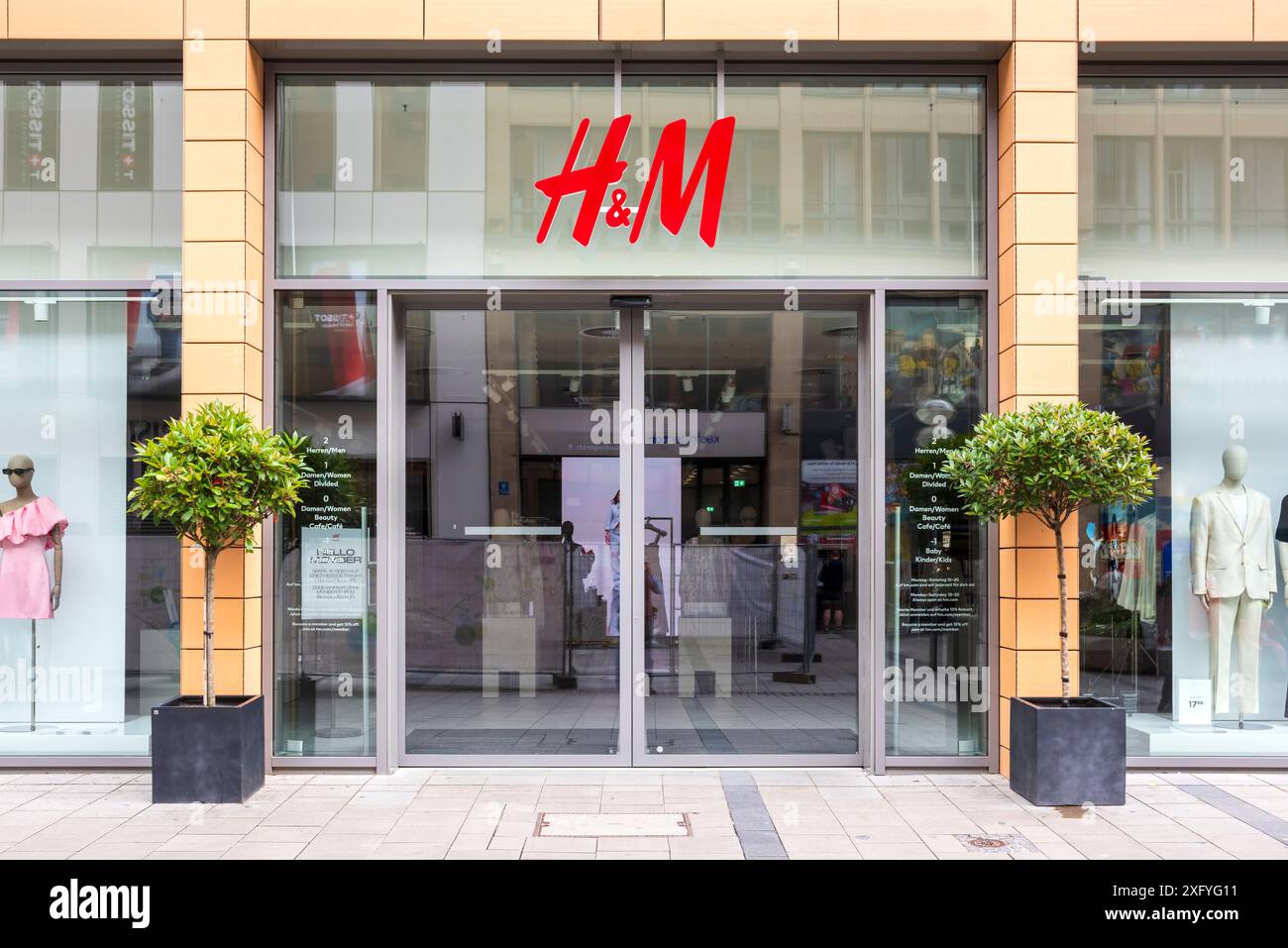 Entrance to the H&M fashion store in Munich's pedestrian zone Stock Photo