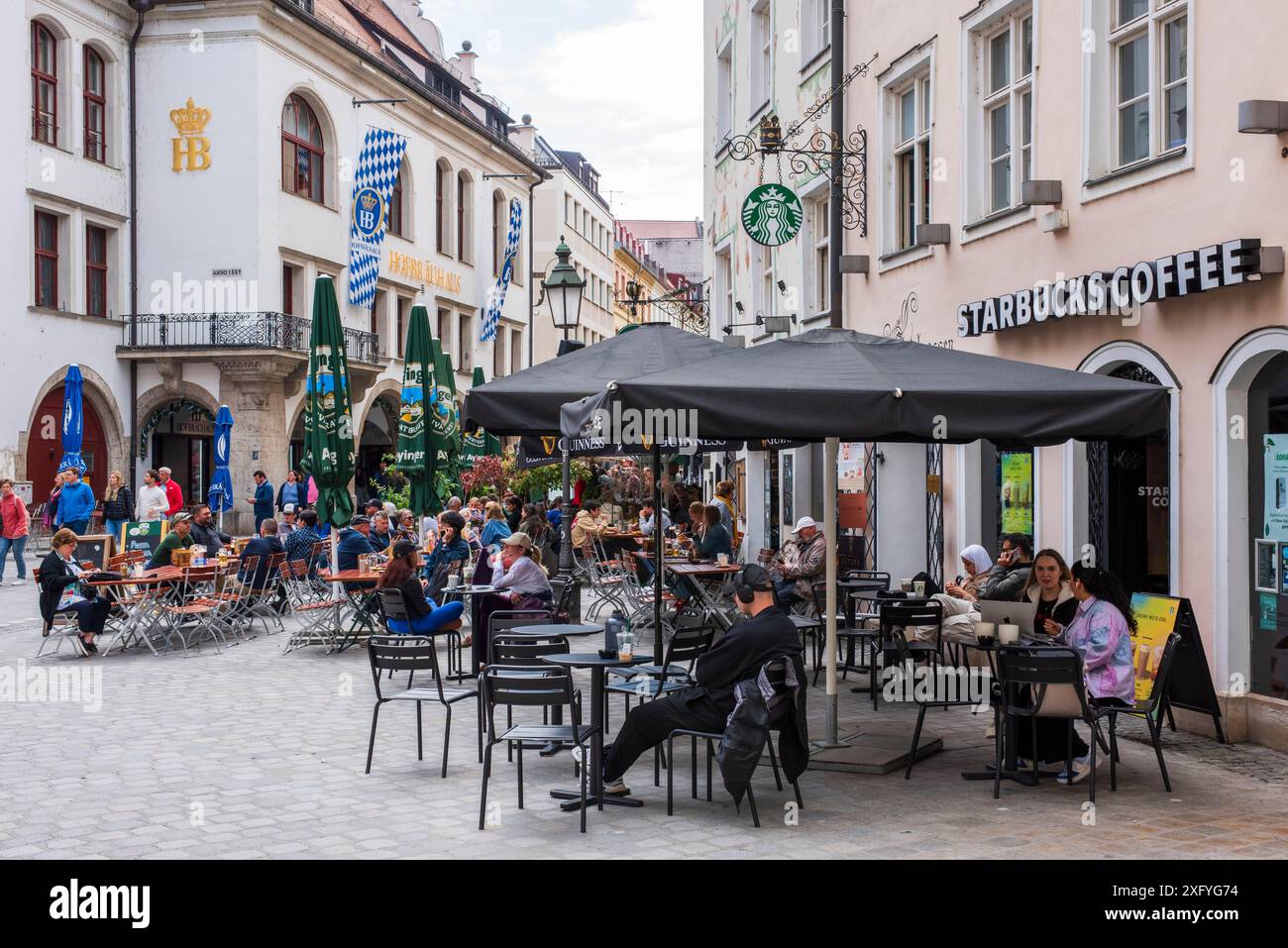 The world-famous Hofbräuhaus on Platzl in Munich's city center with tourists in the beer garden Stock Photo