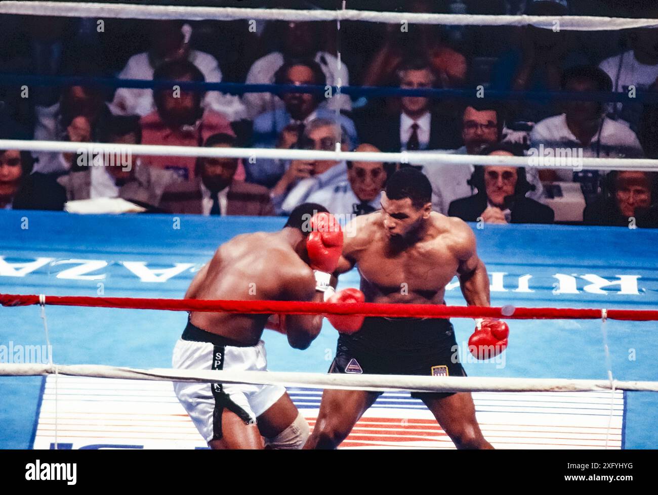 Mike Tyson knocks out Michael Spinks in the first round of their heavy ...