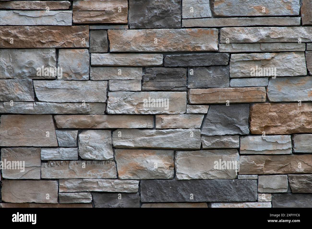 Brown and grey brick stone wall full frame background Stock Photo