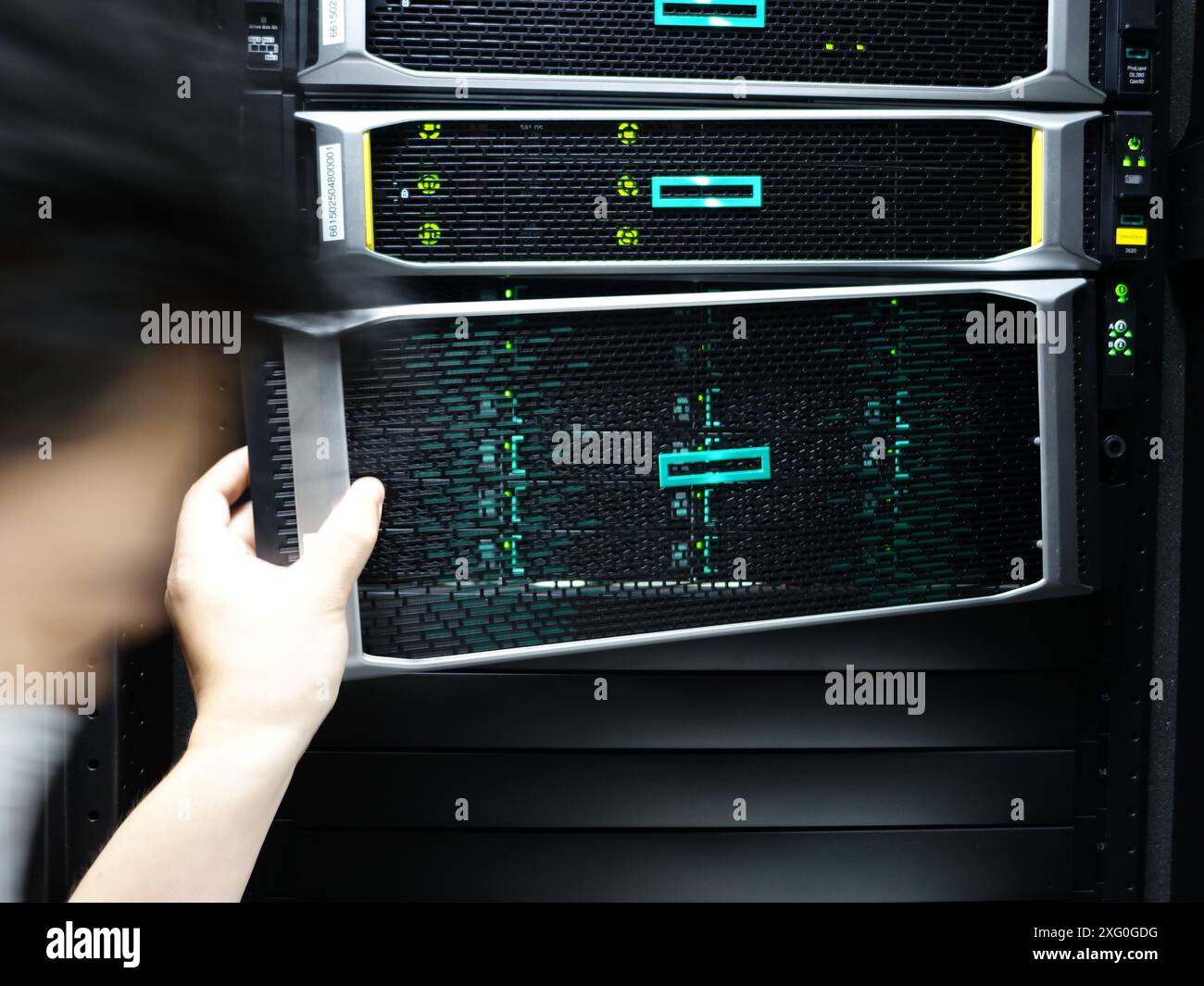 Man fixing server in data center room . Stock Photo