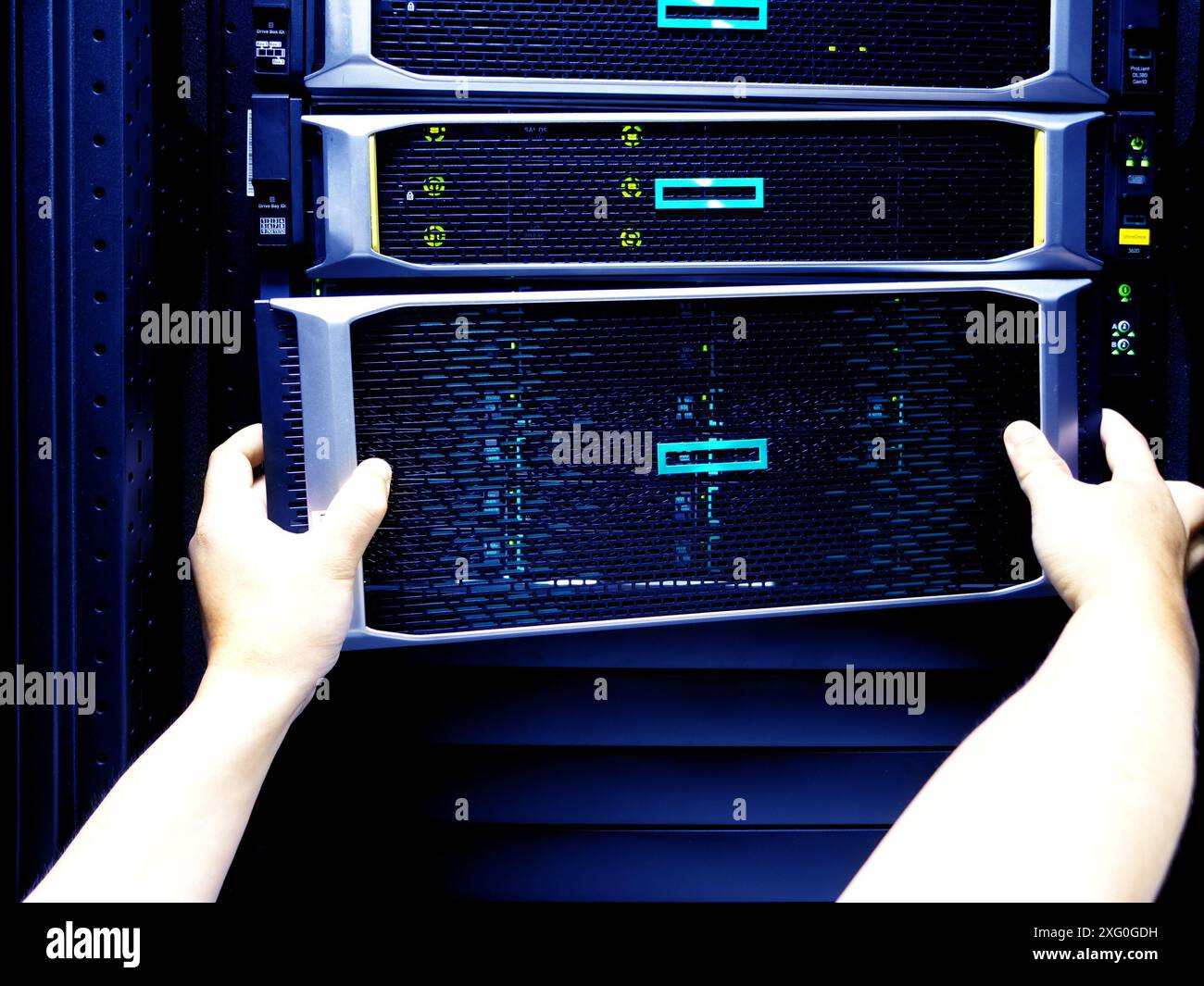 Man fixing server in data center room . Stock Photo
