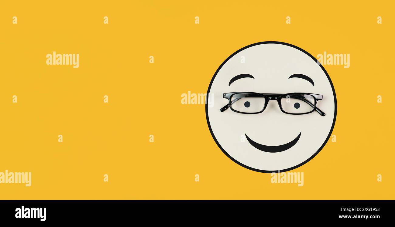 Head with a smiling face and eyeglasses, mental health concept, positive mindset, support and evaluation symbol Stock Photo