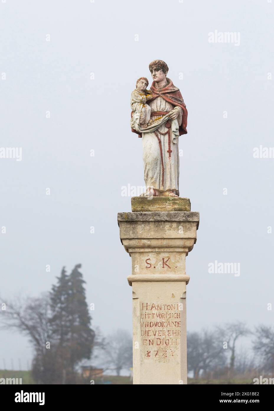 Statue with saint holding baby jesus on a waycross in Burgenland Stock Photo