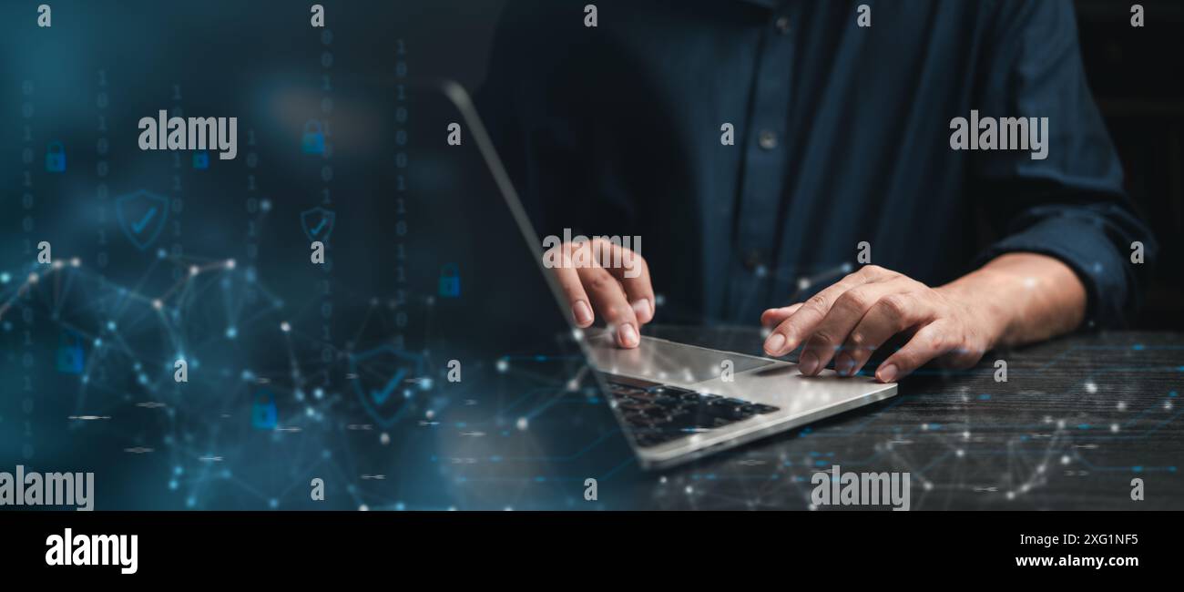 Cybersecurity concept with hands typing on a laptop keyboard, featuring digital security icons overlay. network security, and the role of technology i Stock Photo