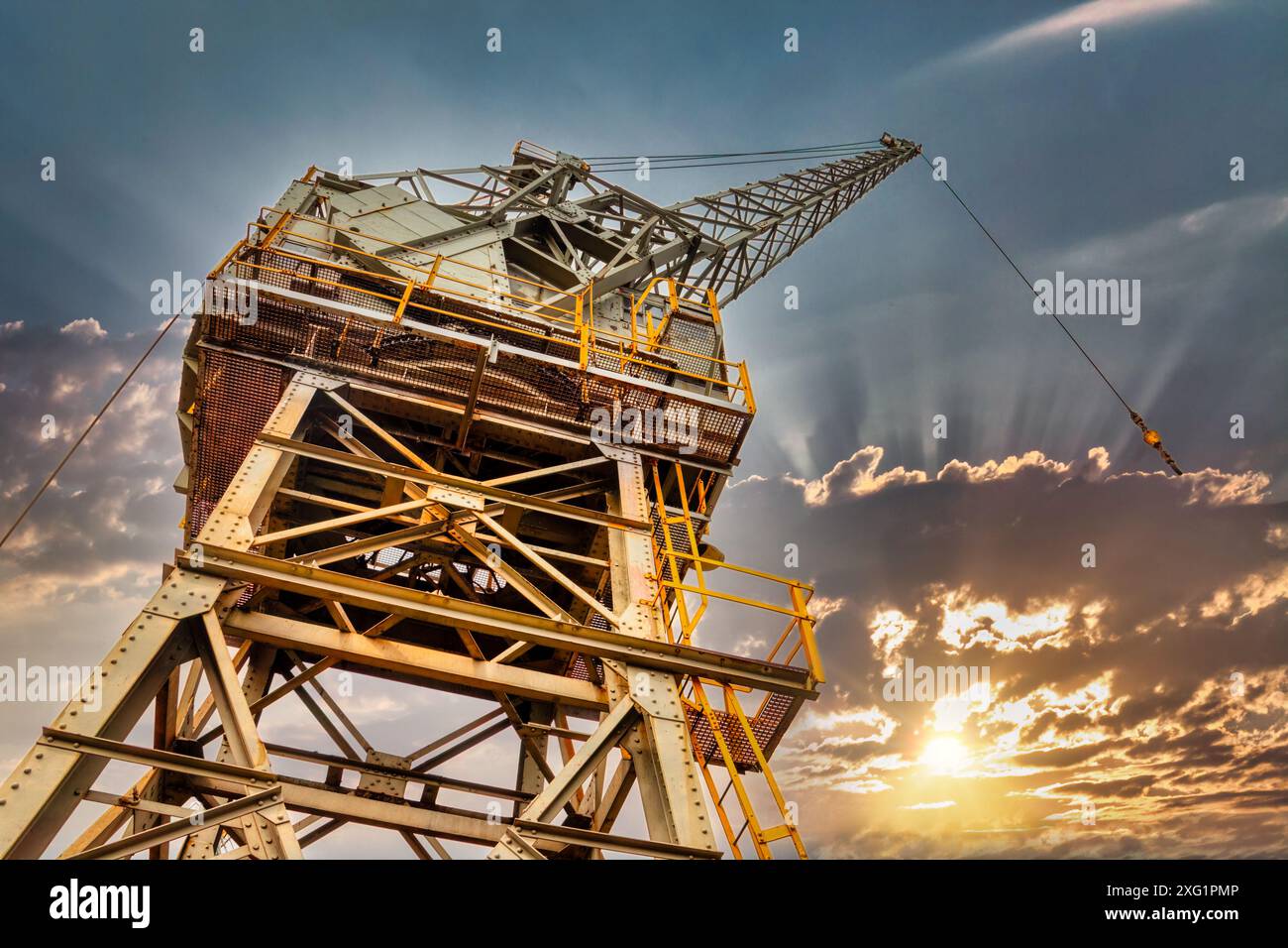 crane loading in a port, sunset sky in the backgrounds Stock Photo - Alamy