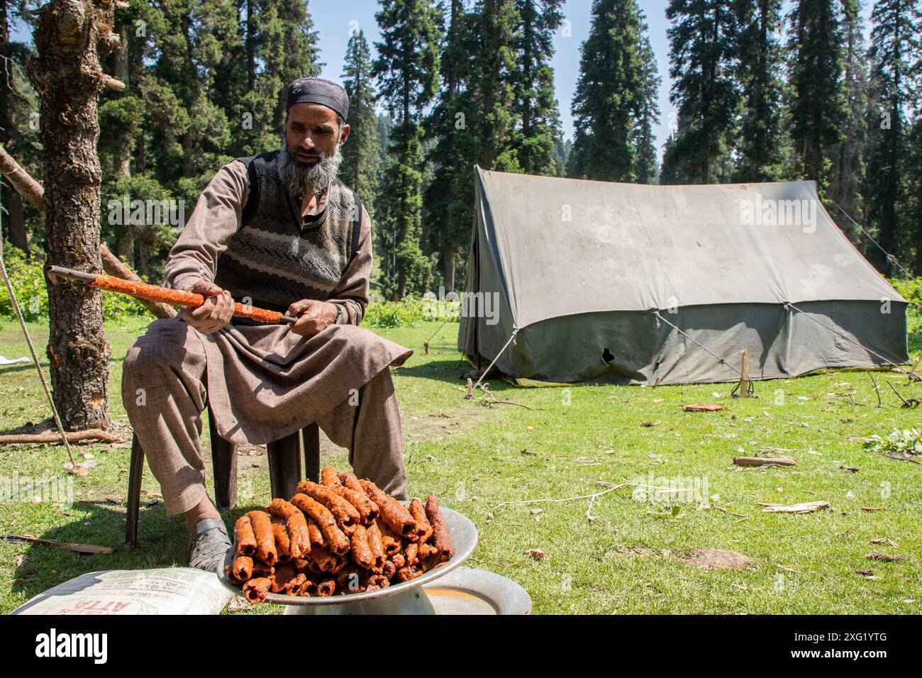 A Gujjar (nomad) chef prepare kebabs for guests during the marriage ...
