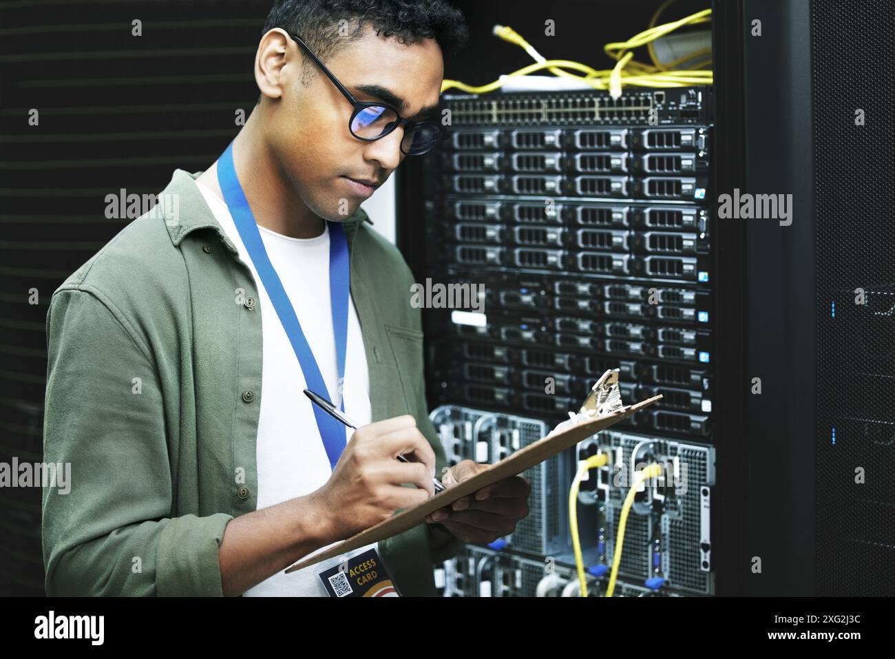 Data center, man and computer engineer with checklist, writing and ...