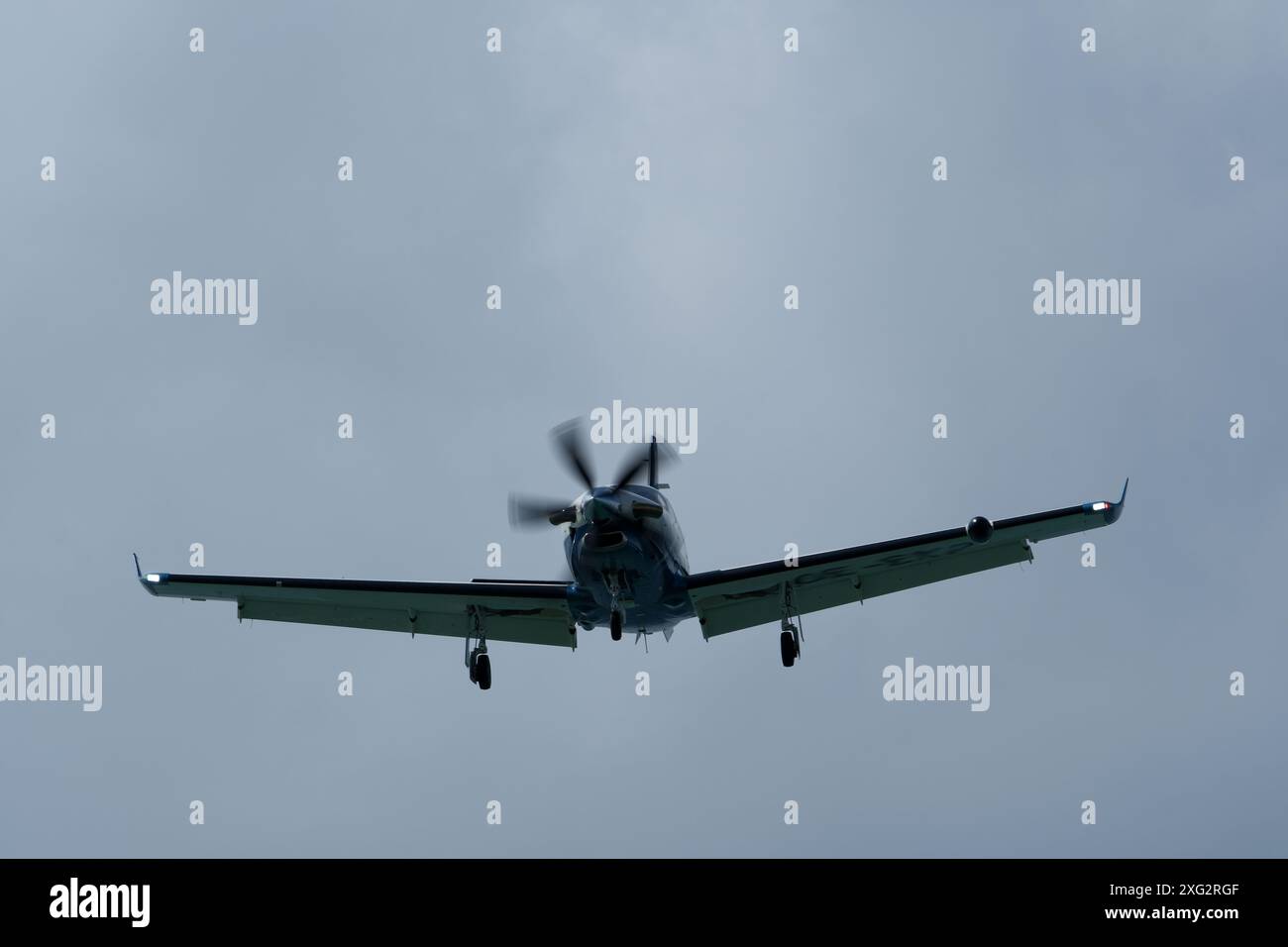 Single-engined turboprop airplane in the cloudy sky Stock Photo - Alamy