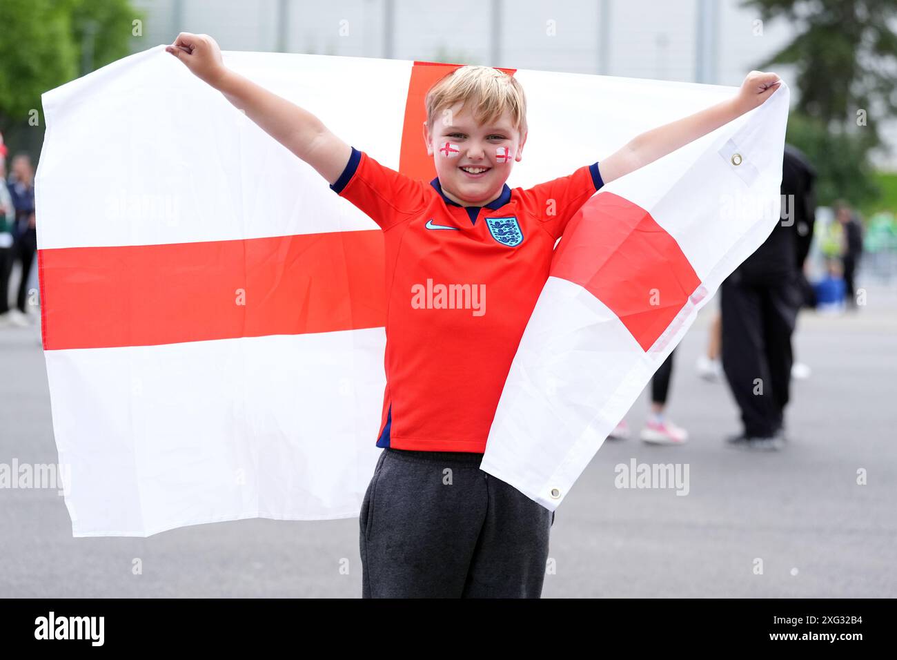A young England fan holds up an England flag ahead of the UEFA Euro ...