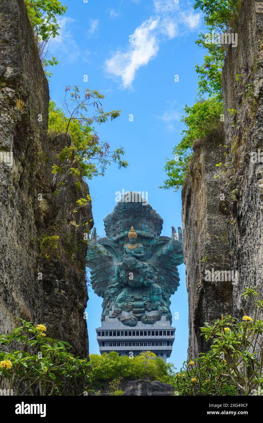 Portrait of the statue of Lord Vishnu against the background of a cloudy blue sky at the Garuda Wisnu Kencana Cultural Park Bali, Indonesia Stock Photo