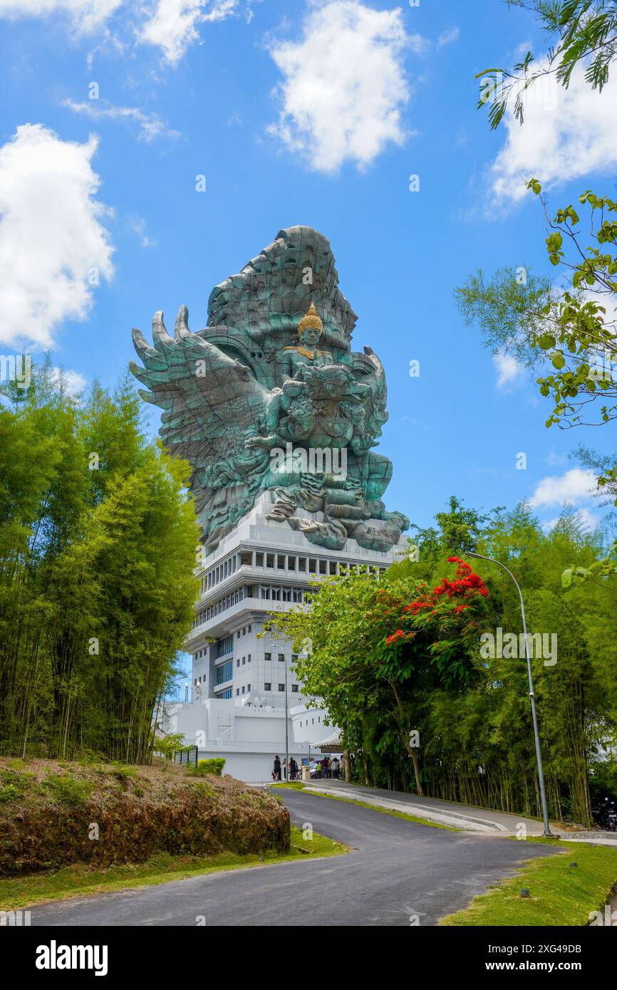 The statue of Lord Wishnu against the backdrop of a cloudy blue sky at the Garuda Wisnu Kencana Cultural Park in Bali, Indonesia Stock Photo