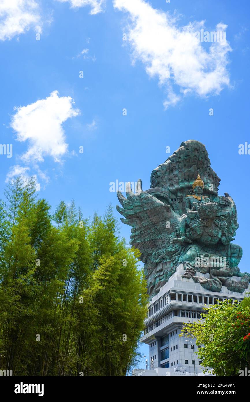 The statue of Lord Wishnu against the backdrop of a cloudy blue sky at the Garuda Wisnu Kencana Cultural Park in Bali, Indonesia Stock Photo
