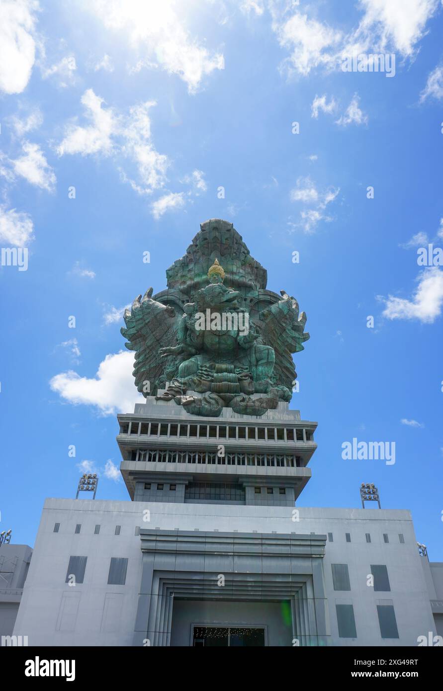 Portrait of the statue of Lord Vishnu against the backdrop of a cloudy blue sky at the Garuda Wisnu Kencana Cultural Park in Bali, Indonesia Stock Photo