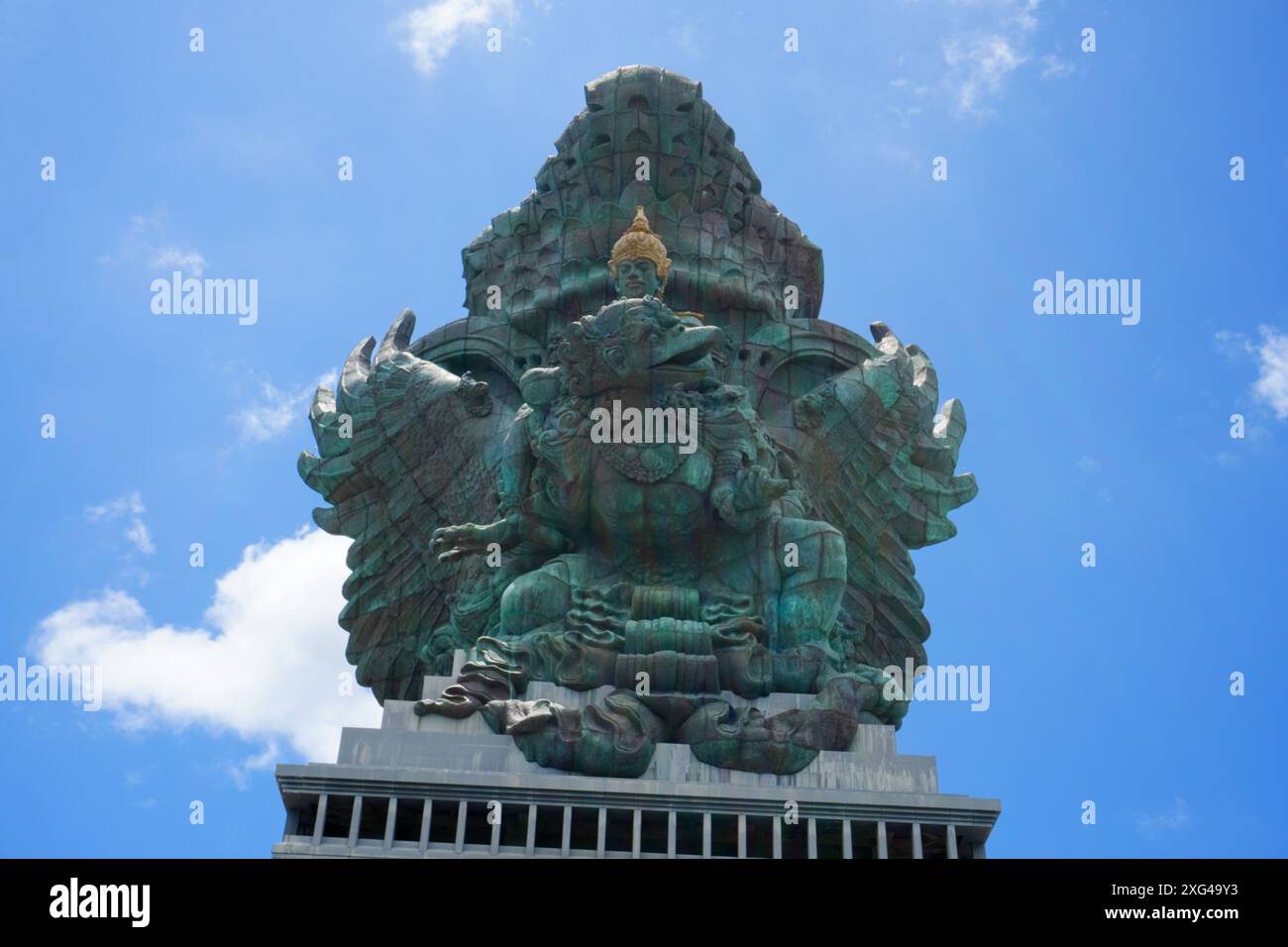 The statue of Lord Wishnu against the backdrop of a cloudy blue sky at the Garuda Wisnu Kencana Cultural Park in Bali, Indonesia. Copy space image Stock Photo