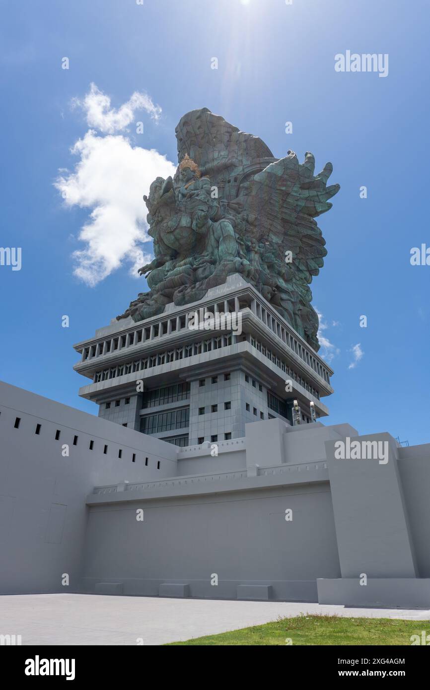 Portrait of the statue of Lord Vishnu against the backdrop of a cloudy blue sky at the Garuda Wisnu Kencana Cultural Park in Bali, Indonesia Stock Photo
