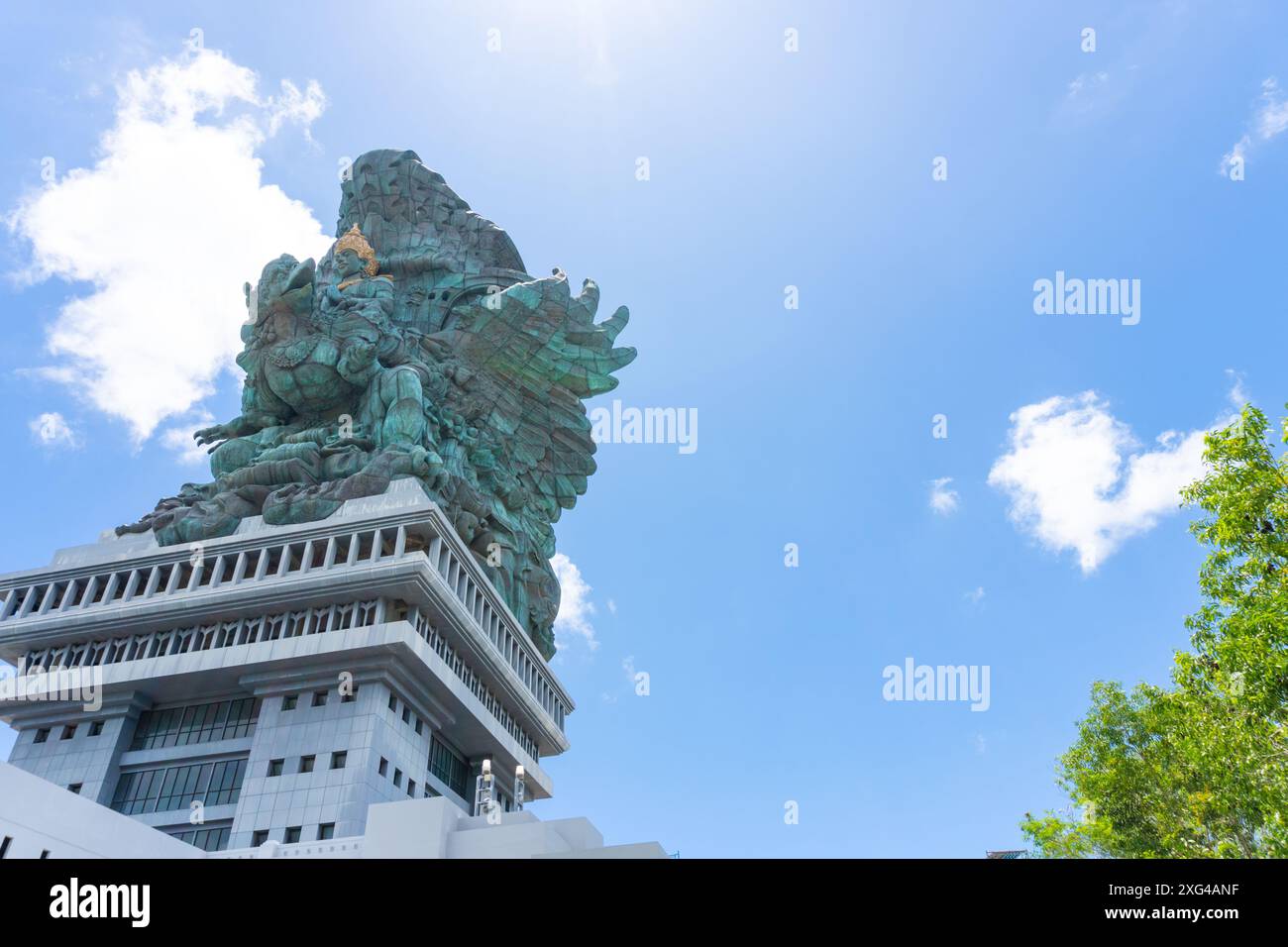 The statue of Lord Wishnu against the backdrop of a cloudy blue sky at the Garuda Wisnu Kencana Cultural Park in Bali, Indonesia. Copy space image Stock Photo