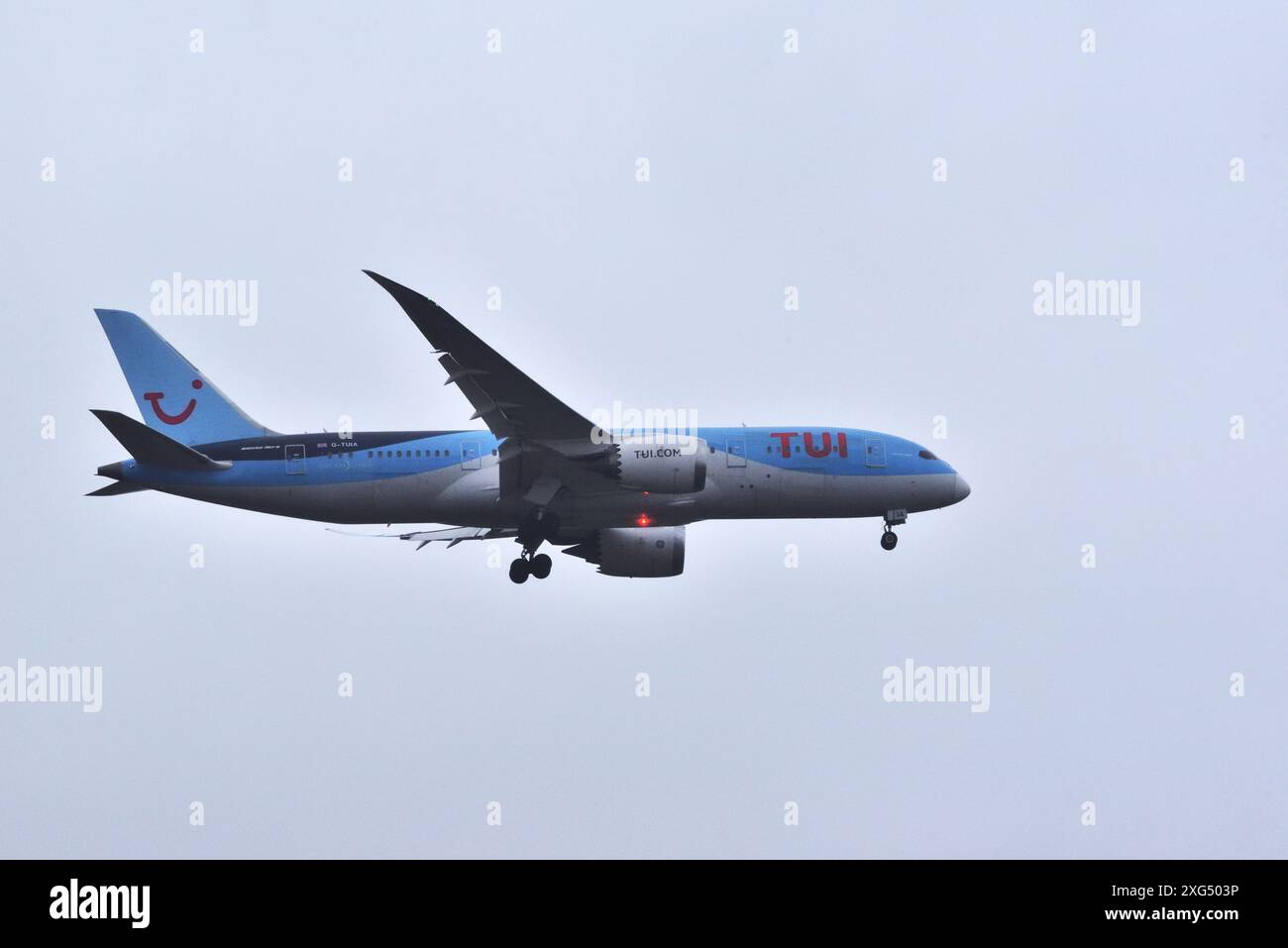 A TUI Airways Boeing 787-8 Dreamliner, registered G-TUIA, is seen on final approach to Bournemouth Airport with a flight from Barbados. Stock Photo