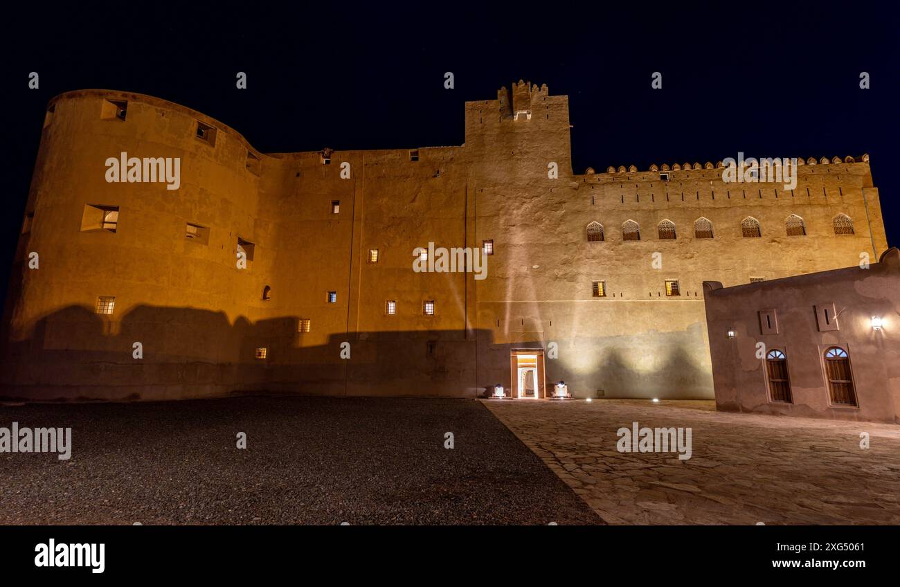 Jabreen citadel fortress stone walls and round bastion tower in night ...