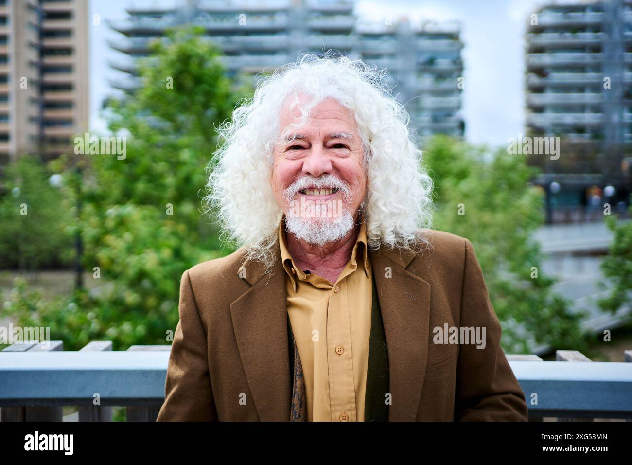 Portrait mature joyful long gray hair and beard male grandfather posing looking smiling at camera. Stock Photo