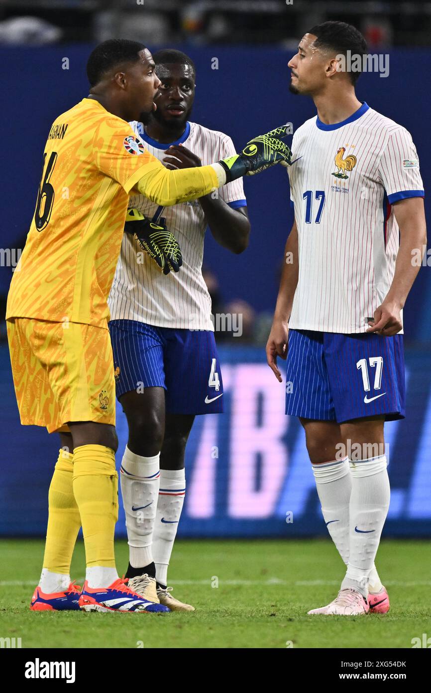 HAMBURG, GERMANY - JULY 5: Mike Maignan, Dayot Upamecano, William Saliba of France during the UEFA EURO 2024 quarter-final match between Portugal and Stock Photo