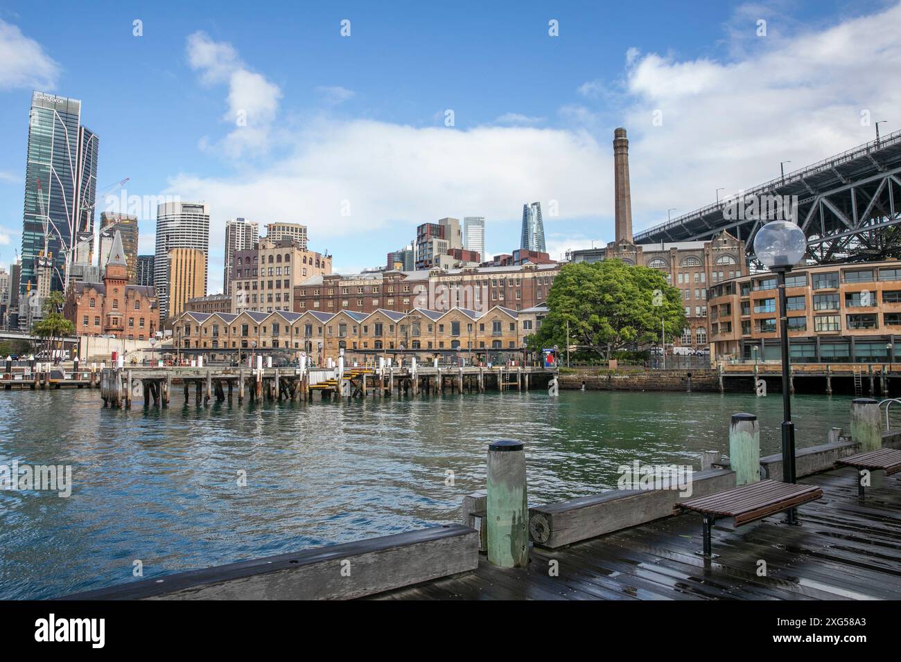 Sydney city centre, historic Rocks precinct with Campbells Cove old warehouses, Park Hyatt hotel, Salesforce tower and city skyscrapers, Sydney,NSW Stock Photo