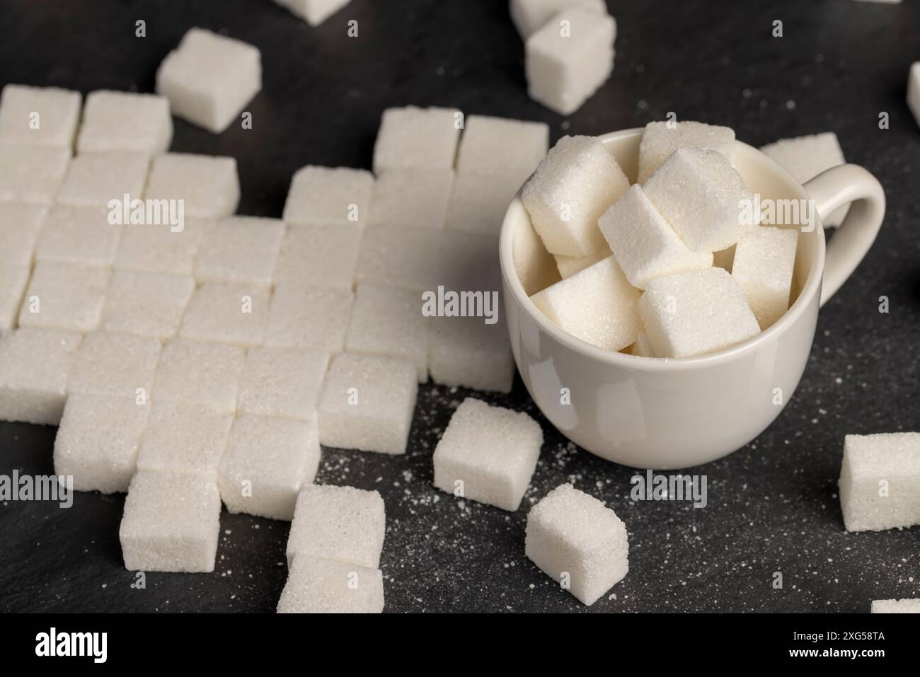 white square sugar on a black background , lump sugar in the shape of a ...