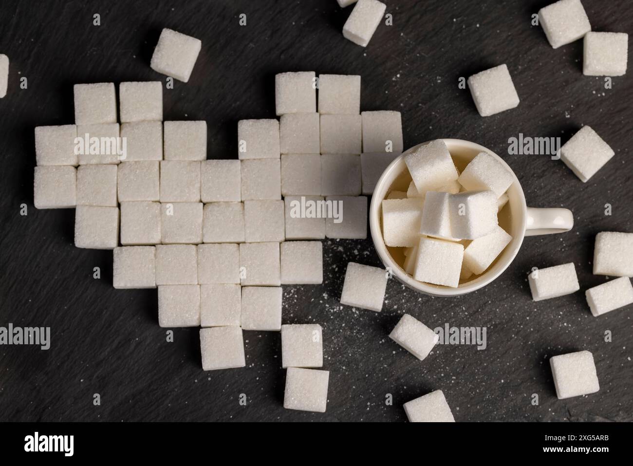 white square sugar on a black background , lump sugar in the shape of a ...