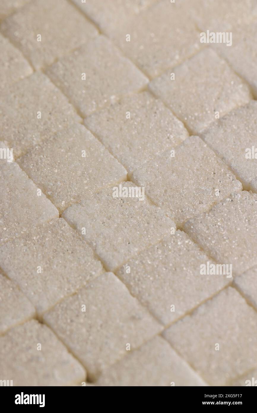white square sugar on a black background , lump sugar in the shape of a ...