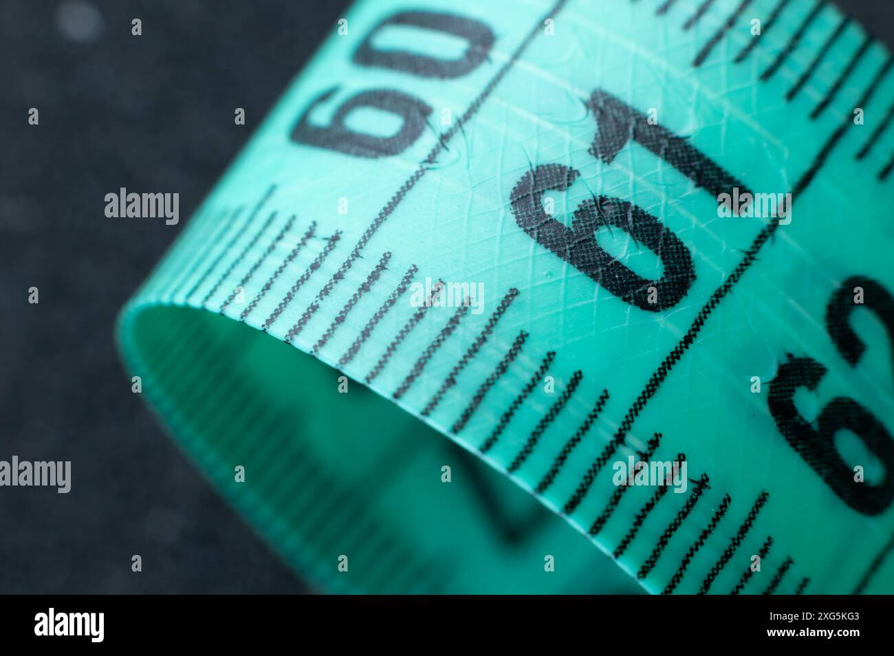 Code 61 Measurement Close-up of rolled up tape measure on number 61. Slim waist and healthy ...