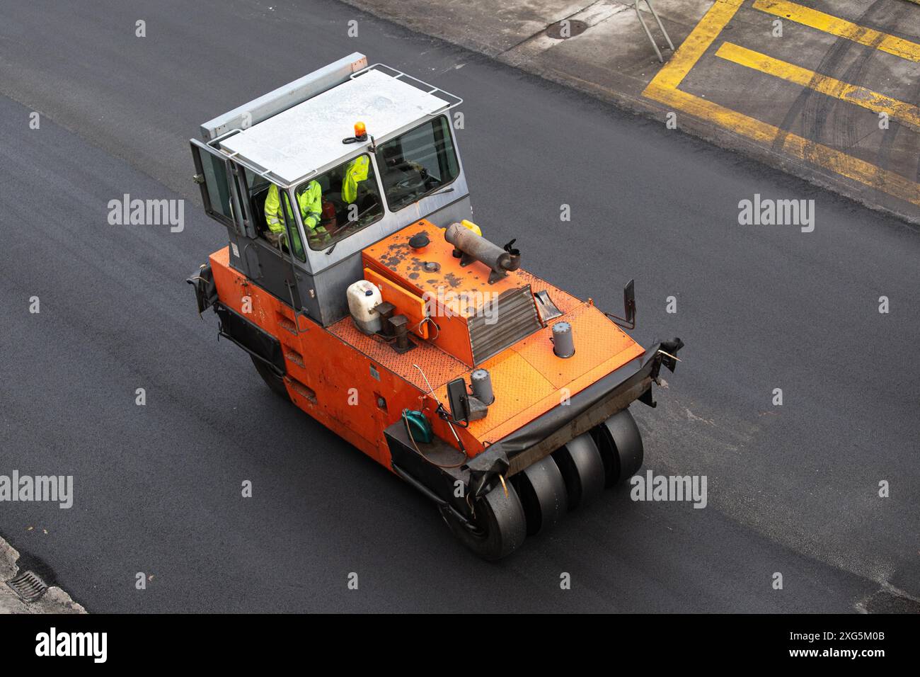 Vibrating roller working on Road construction. Asphalt paving. High angle view Stock Photo