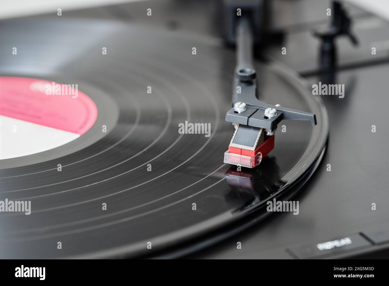 Record player playing a vinyl record. Black platter Stock Photo - Alamy