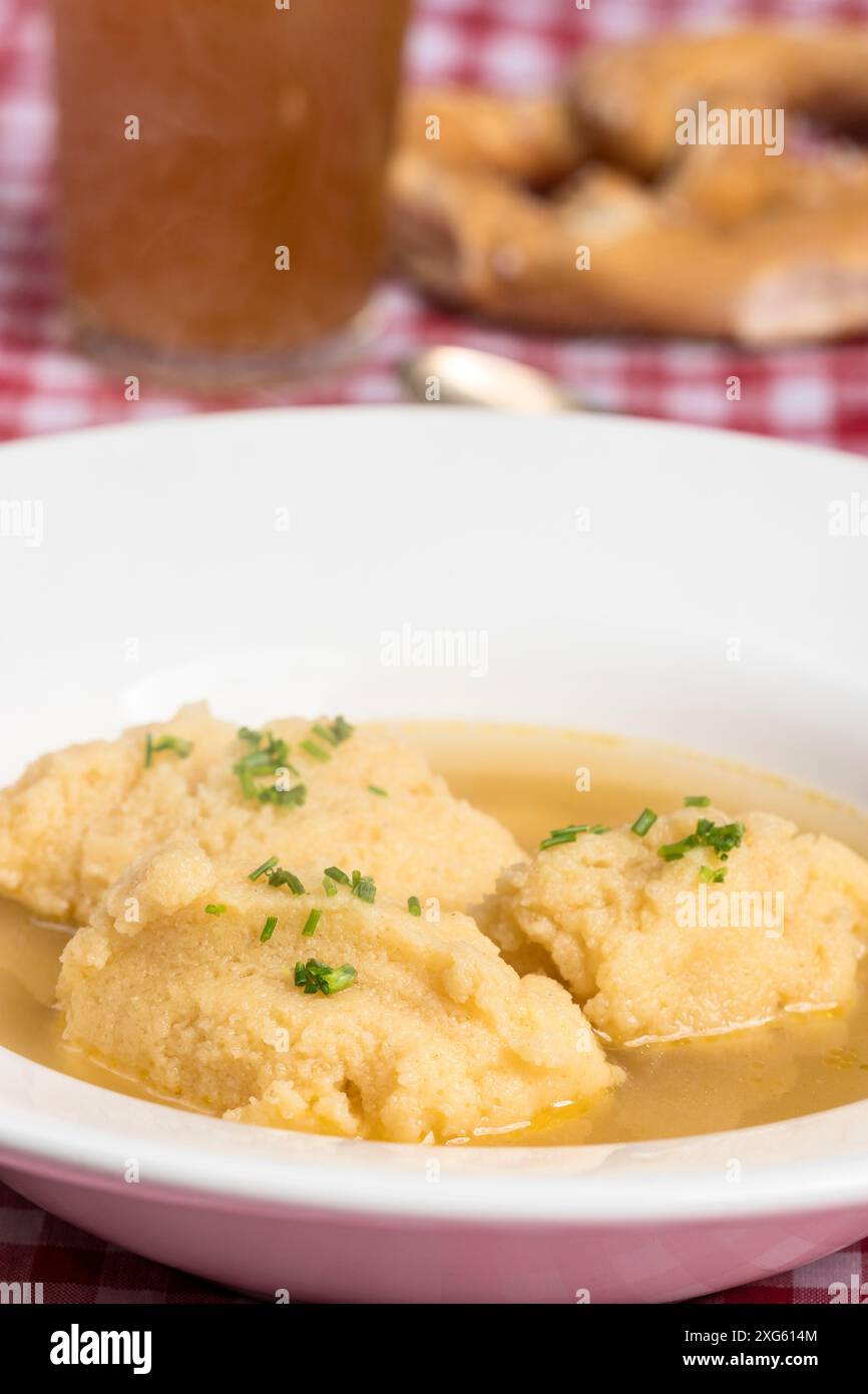Bavarian dumpling soup on tablecloth Stock Photo