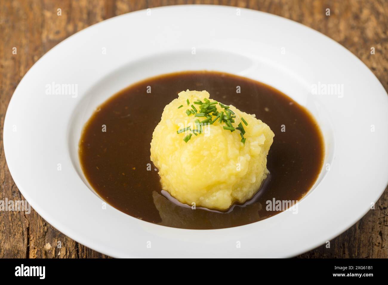 Bavarian dumpling in a plate with sauce Stock Photo