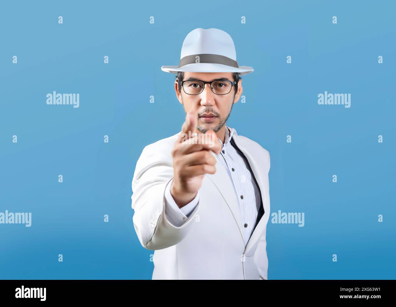 Asian model pointing finger at camera showing seriousness on isolated background. Can be used for advertisements to attract attention to you Stock Photo