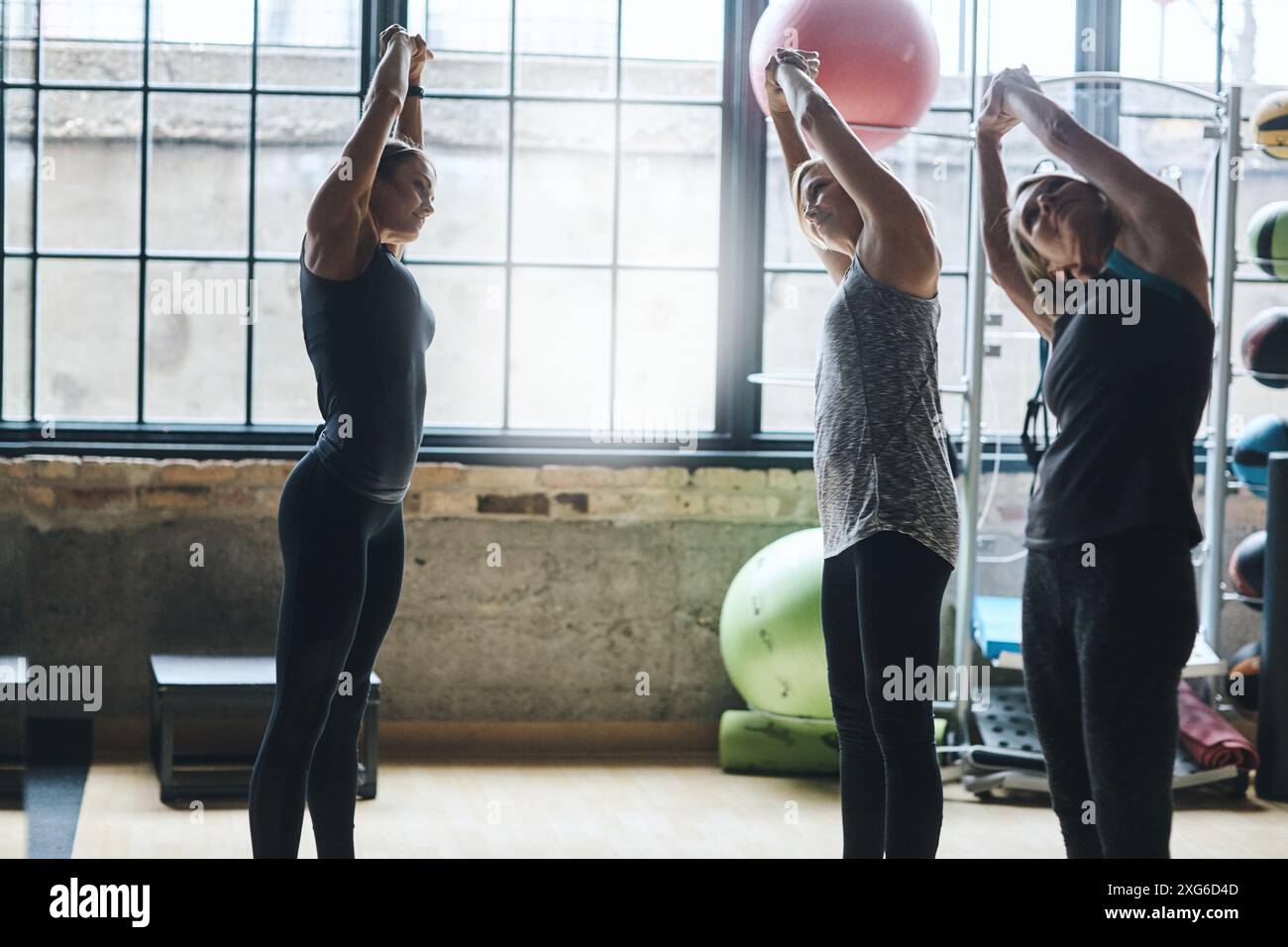 Instructor, group and stretching in gym with training for arm exercise ...