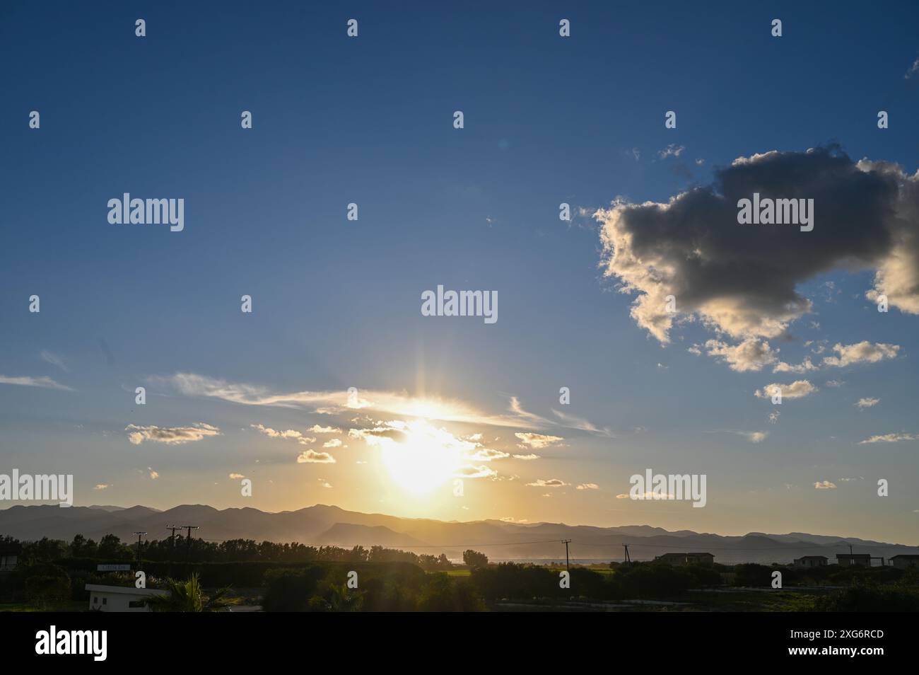 the sun sets behind the mountains in Cyprus 2 Stock Photo